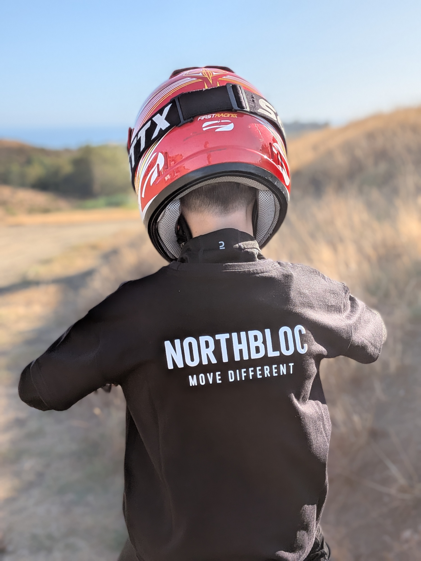 Close view of the NORTHBLOC MOVE DIFFERENT print across the back of the tee